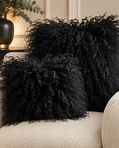 Black Mongolian fur cushions, 45cm and 60cm, on a cream boucle sofa - handmade curly lamb fur cushions [shade: Black]