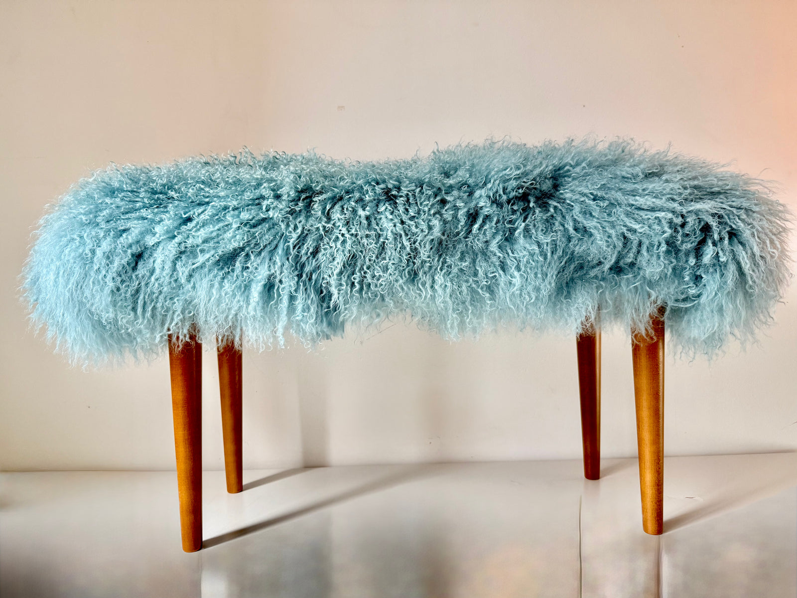 Handmade duck egg Mongolian fur single bench on solid wood tapered legs, photographed in our London studio