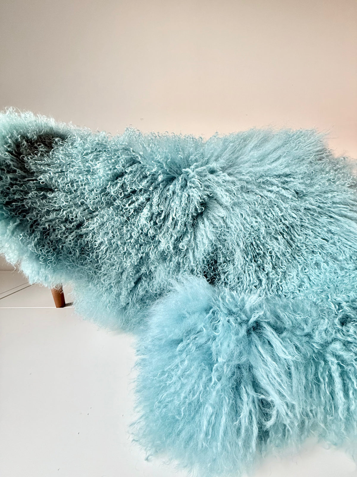Duck Egg Mongolian fur single throw draped over a bench