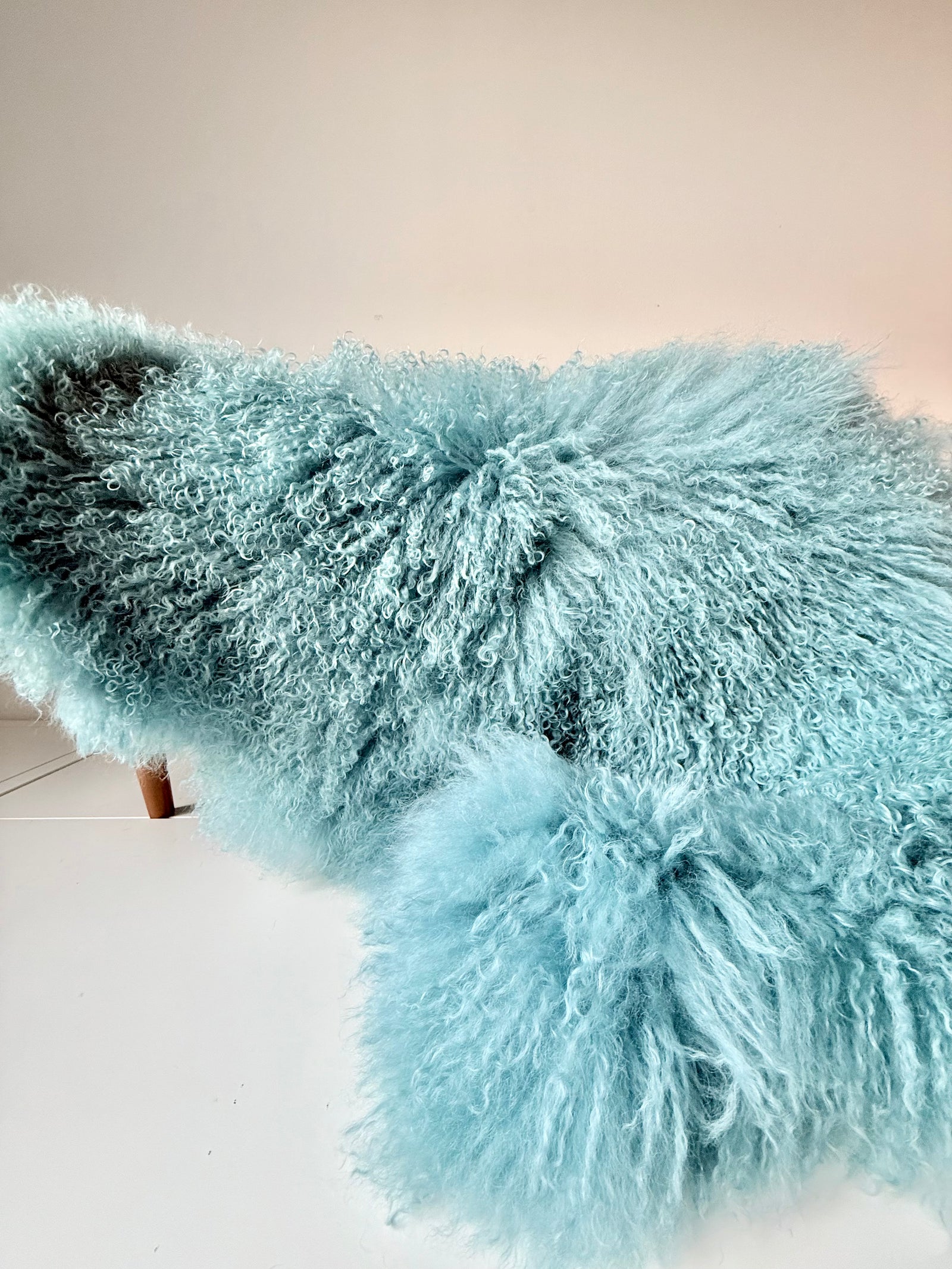 Duck Egg Mongolian fur single throw draped over a bench