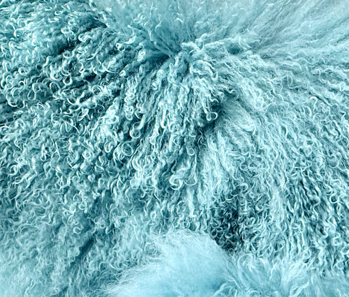 Handmade Mongolian fur sample swatch in duck egg blue, close-up of the curly fur