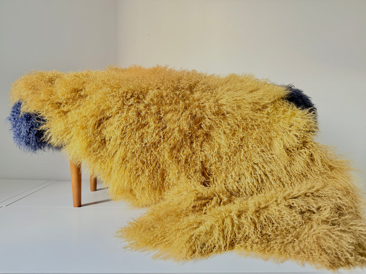 Sandstorm Mongolian fur single throw draped over a bench