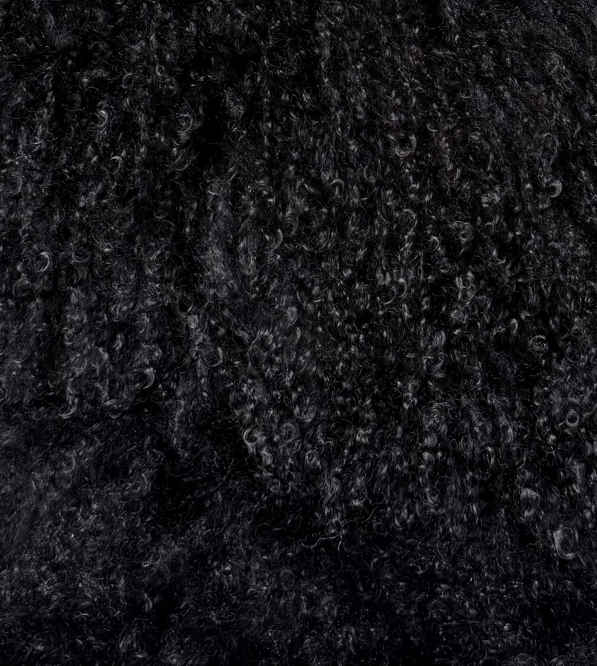 Black Mongolian fur, close up of the curl