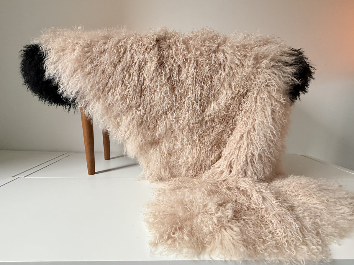 Oyster Mongolian fur single throw draped over a bench