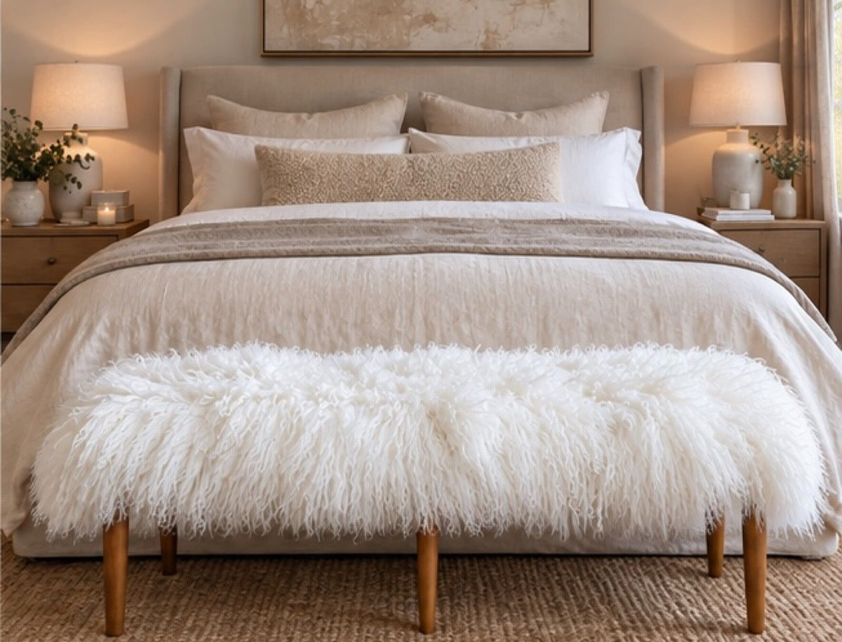 Handmade white Mongolian fur tapered leg bench at the end of a queen bed