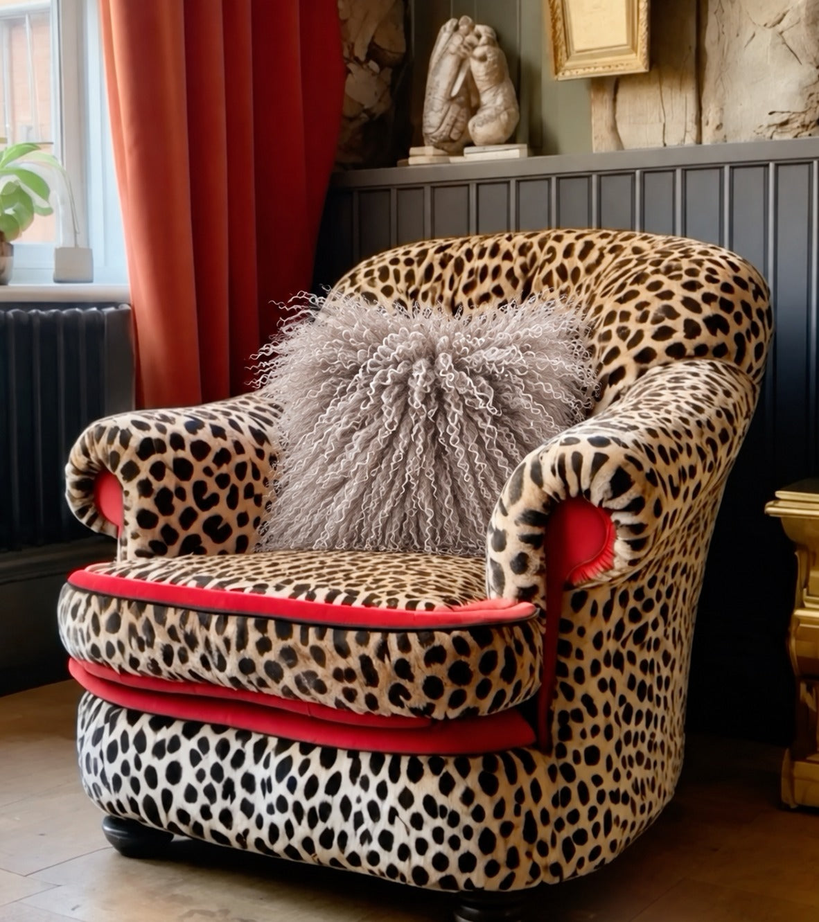 Grey Mongolian fur cushion, 45cm, on a leopard print armchair - handmade fluffy grey curly lamb fur cushion